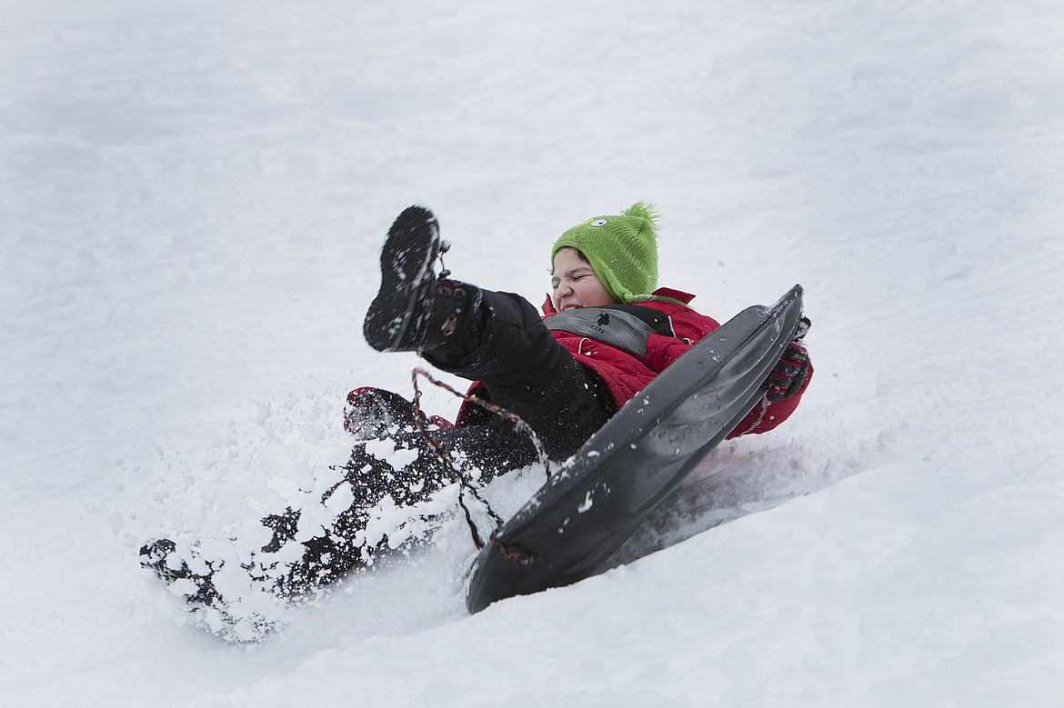 Canaan Lhevalley, 12, takes a spill on Cherry Hill in Coeur d&#146;Alene on Saturday during a sledding outing with his family.

BETHANY BLITZ/Press