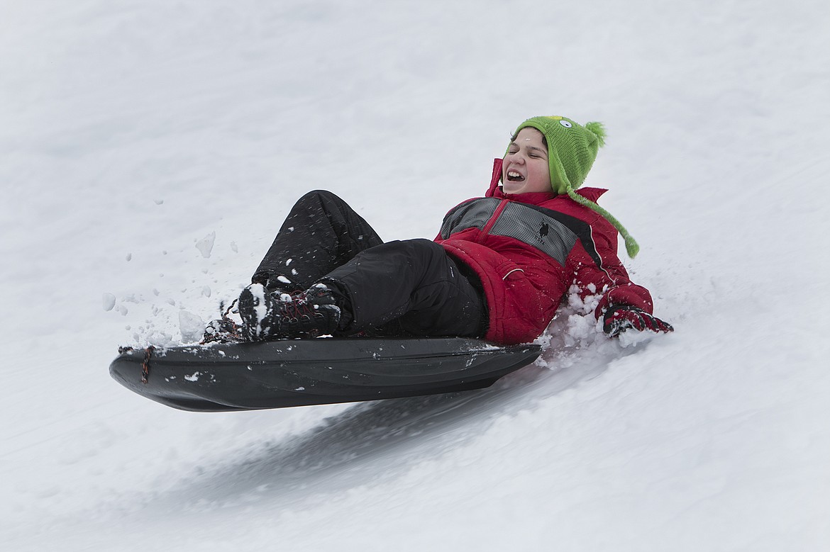 BETHANY BLITZ/PressCanaan Lhevalley, 12, sleds on Cherry Hill Saturday during an outing with his family.