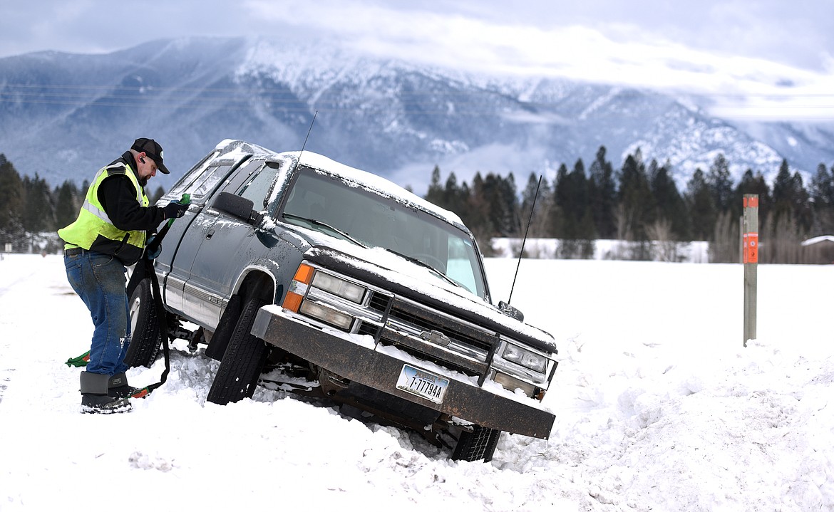 Sean Delaney of OHS&#146; Body Shop prepares to pull a truck out of a ditch on Walsh Road on Monday in Columbia Falls. Delaney said OHS&#146; had six drivers responding to requests for assistance on Monday morning, and he alone had 14 calls after he finished with this truck.