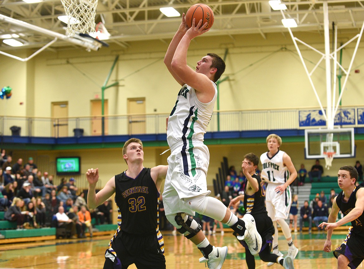 Glacier post Jaxen Hashley makes a basket on a lob pass against Missoula Sentinel on Saturday. (Aaric Bryan/Daily Inter Lake)