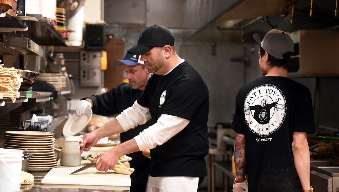 VISCONTI WITH Chuck McWilliams, left, and Forest Bradley, right, working in the busy kitchen at Fatt Boys.