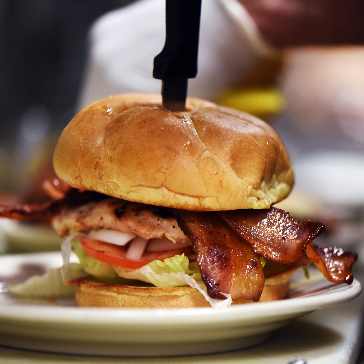 A CUSTOM chicken sandwich with bacon prepared by Visconti.