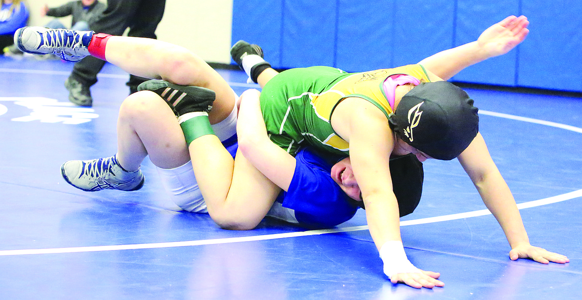 Connor Vanderweyst/Columbia Basin Herald
Quincy's Cynthia Diaz falls on top of Warden's Mariah Garza for a take-down and last-second win in the 110-pound championship.