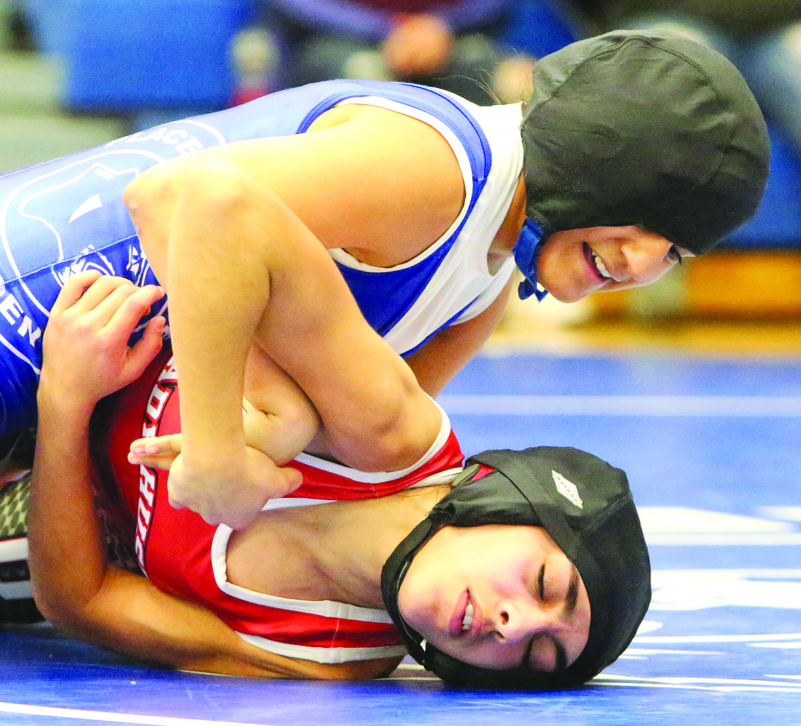 Connor Vanderweyst/Columbia Basin Herald
Warden's Angelica Vela works to get Othello's Emily Mendez onto her back during the 105-pound district final.