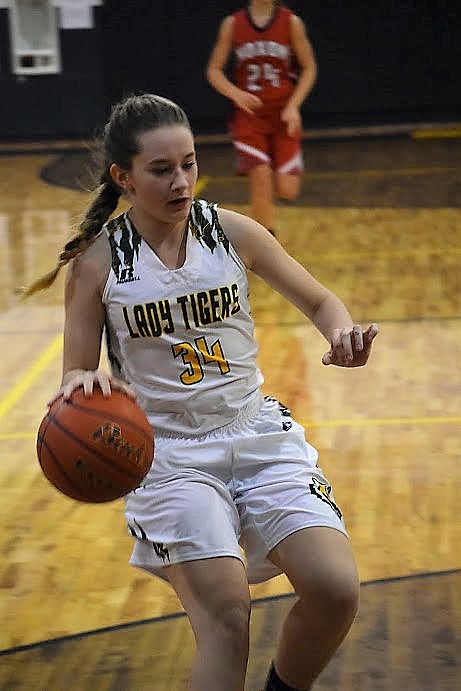 Kylee Thompson takes the ball down the court during an earlier game against Noxon. (Photo by McKenzie Stortz).