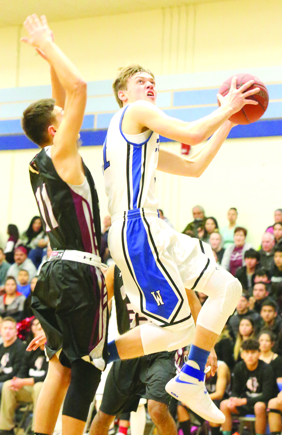 Connor Vanderweyst/Columbia Basin Herald
Warden guard Adam Richins tries to adjust in the air to get a shot off against Wahluke.