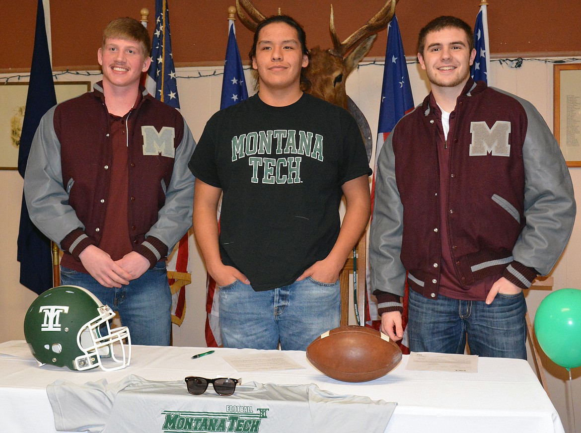 POLSON FOOTBALL players Matthew Rensvold (left), Johan Burke (middle), and Tanner Wilson (right) all sign their letters of intent to play college football on National Signing Day Feb. 1 at the Polson Elks Lodge. Rensvold and Wilson signed their letters with the University of Montana-Grizzlies and Burke signed with NAIA school Montana Tech in front of several fans and well-wishers in the community. (Jason Blasco/Lake County Leader)