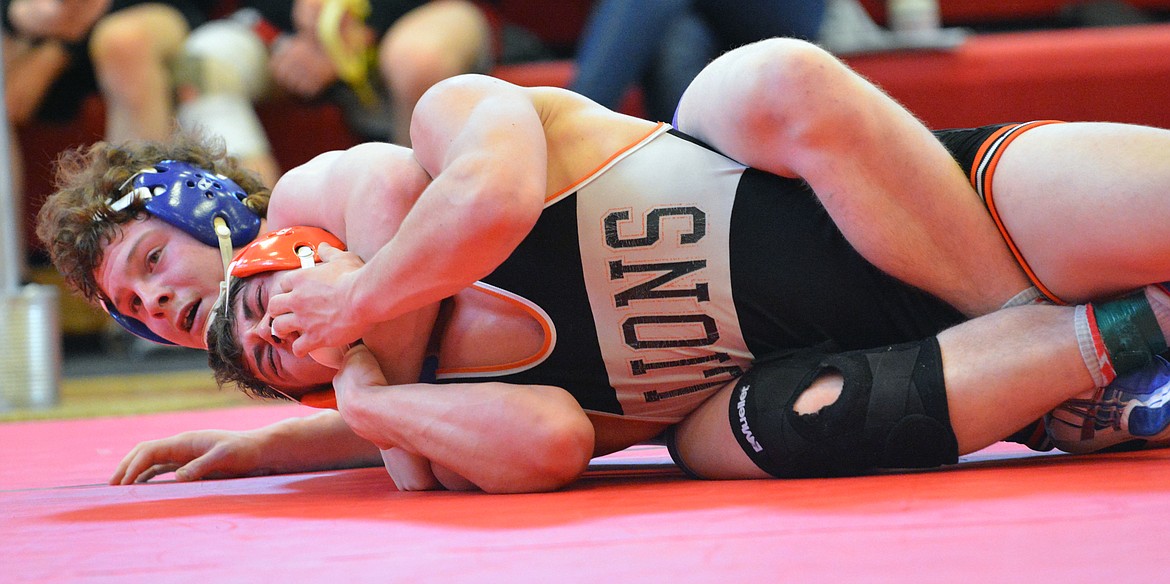 MISSION-CHARLO wrestler Gus Bosley attempts to pin Eureka wrestler Garrett Graves in the championship round of the Western B-C Divisionals Saturday afternoon at Arlee High School. (Jason Blasco/Lake County Leader)