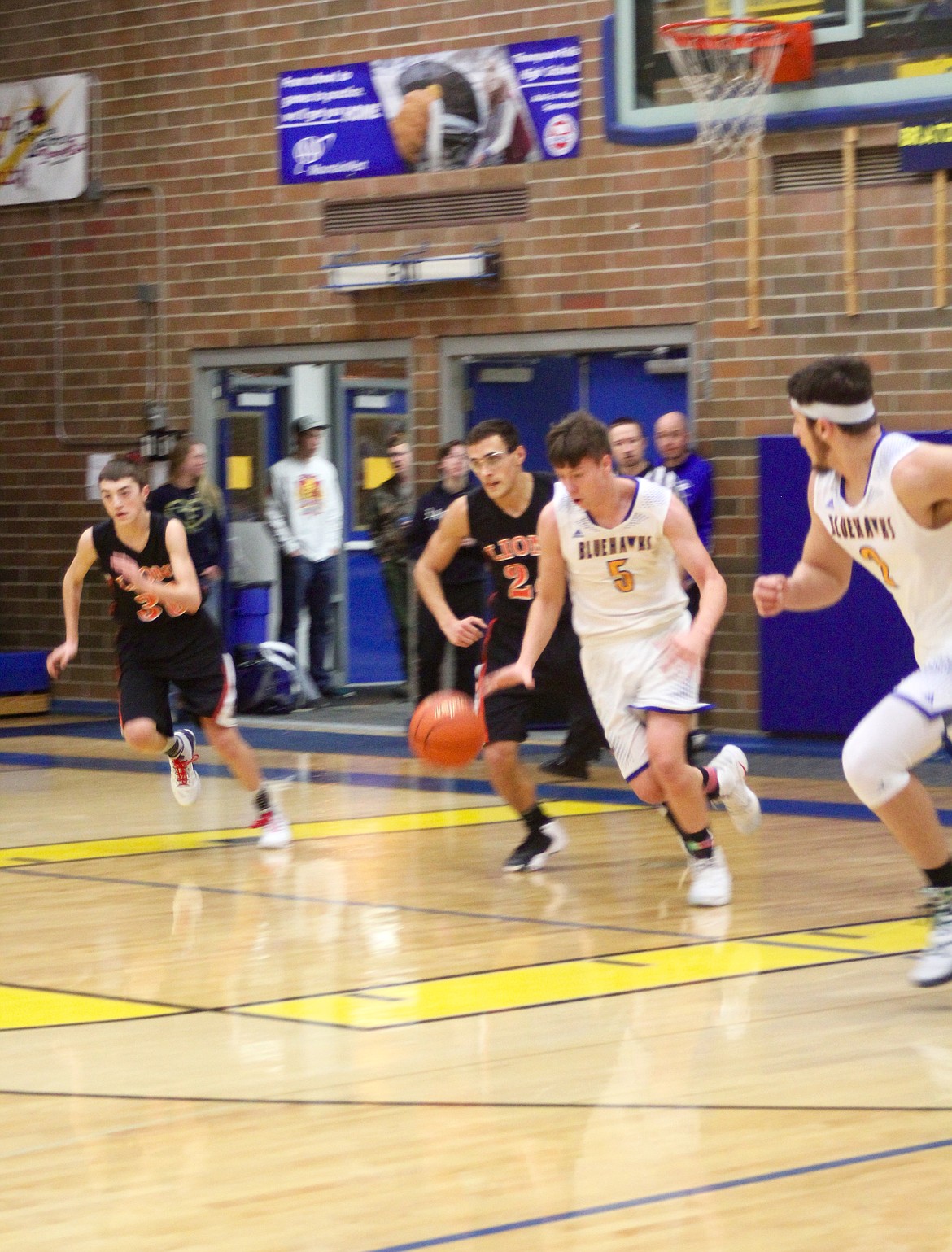 DANNY HOISINGTON (5) and Dylan Beckman (3) of the Bluehawks begin their offense play against the Eureka Lions.