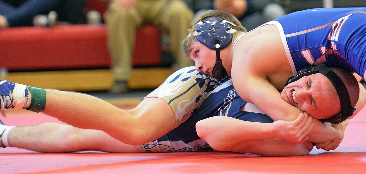 Superior wrestling Trey Green puts Thompson Falls wrestler Luke Furhman in a strangle hold at the Class B-C Western Divisional round Saturday night at Arlee High School. (Jason Blasco/Lake County Leader)