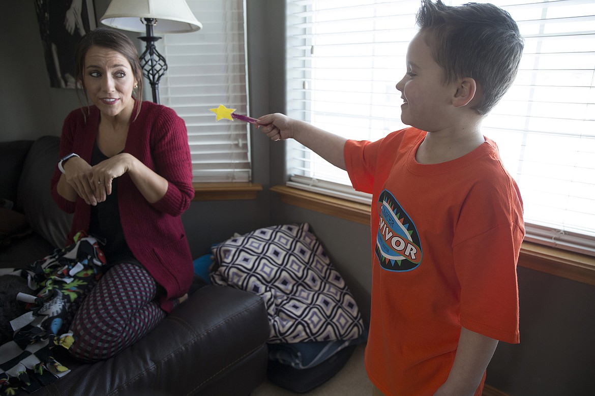 LISA JAMES/ PressTyce Fuqua, right, uses his magic wand to turn his mother Stacy into mouse, at their Hayden home on Tuesday. After 3 years and 3 months of leukemia treatment, Tyce rang the &quot;Cancer free&quot; bell last Thursday,  his last day of treatment.