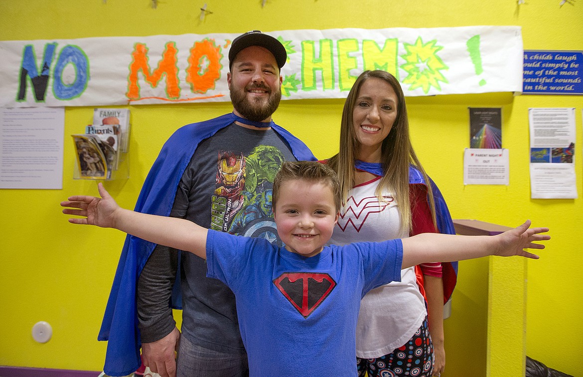 LISA JAMES/ PressTyce Fuqua, 5, pictured with his parents Keith and Stacy, celebrated his last day of chemotherapy with a superhero themed celebration at Jump for Joy in Coeur d'Alene on Thursday night. About 100 friends and family members joined the kindergartner to mark the end of his 3 years and 3 months of leukemia treatment.