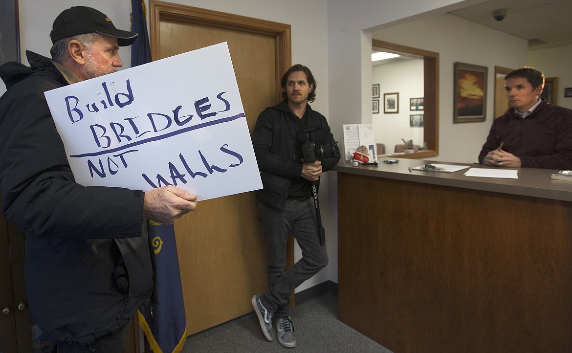 Guy States, left, voices his request for Sen. James Risch&#146;s statement on President Trump&#146;s executive order on immigration to Risch&#146;s regional director, Sid Smith, far right, as Tuevo Orjala listens at Risch&#146;s Coeur d&#146;Alene office on Tuesday afternoon.