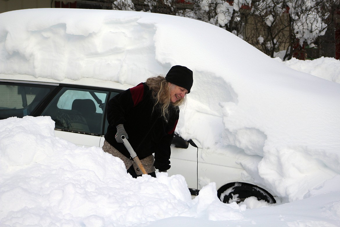 &#151;Photo by STAR SILVA
Bonners Ferry resident, Cher Milne, shovels her car out of the driveway at her residence on Augusta Street on Monday after an estimated 36 inches of snowfall accumilated over the past two days.