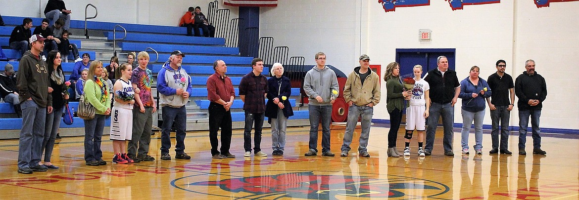 Band members and girl basketball players escort parents during Senior Night on Friday in Superior. (Kathleen Woodford/Mineral Independent).