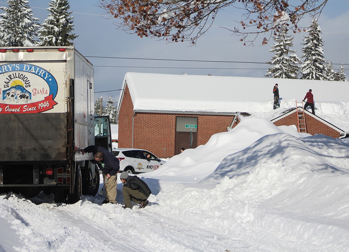 &#151;Photo by STAR SILVA
Terry&#146;s Dairy driver, Chad Collop, chains up on Monday after he gets stuck on on Augusta Street while attempting to deliver milk to Valley View Elelmentary School. Meanwhile, KHQ News 6 receives assistance from locals after getting stuck in front of Collop while filming local residents  who volunteered to shovel snow off of the Valley View school&#146;s infrastructures. Two vehicles behind Collop and KHQ were stuck as well and received assistance from Boundary Tractor.