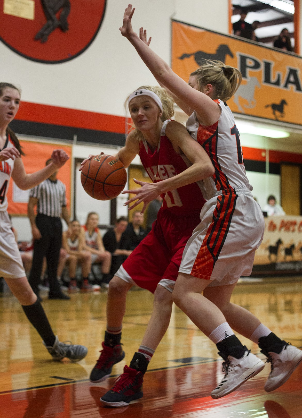 ARLEE HIGH School forward/guard Carly Hergett slides to the rim in the game against Plains Friday night at Plains High School. (Jeremy Weber/Lake County Leader)