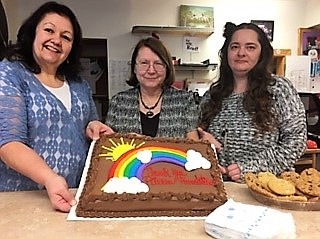 Library Director Guna Chaberek (center) helps display a cake celebrating a donation from the Pilcrow Foundation to supplement children&#146;s math and science books. (Photo courtesy of Mineral Community Library).