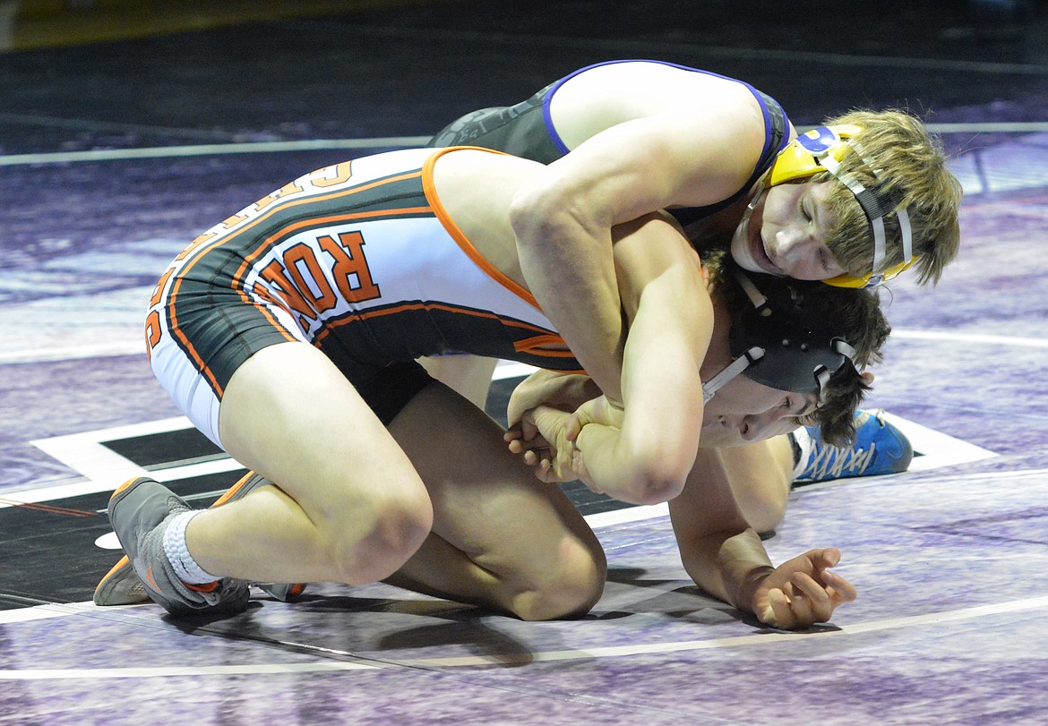 POLSON WRESTLER Cameron Brown attempts to pin Ronan wrestler Seth Cheff in the dual with Ronan Saturday night at Polson High School. This match marked the debut of Brown after accidently shooting himself with a .22-caliber pistol prior to the start of the wrestling season. (Jason Blasco/Lake County Leader)