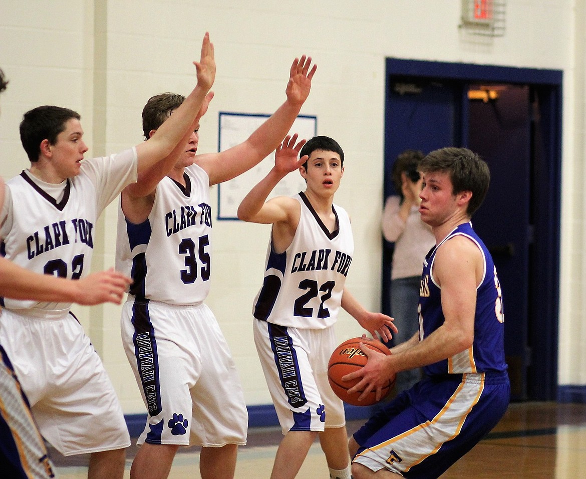 A Thompson Falls player looks for an opportunity to pass the ball while several Clark Fork players aim to block his shot.