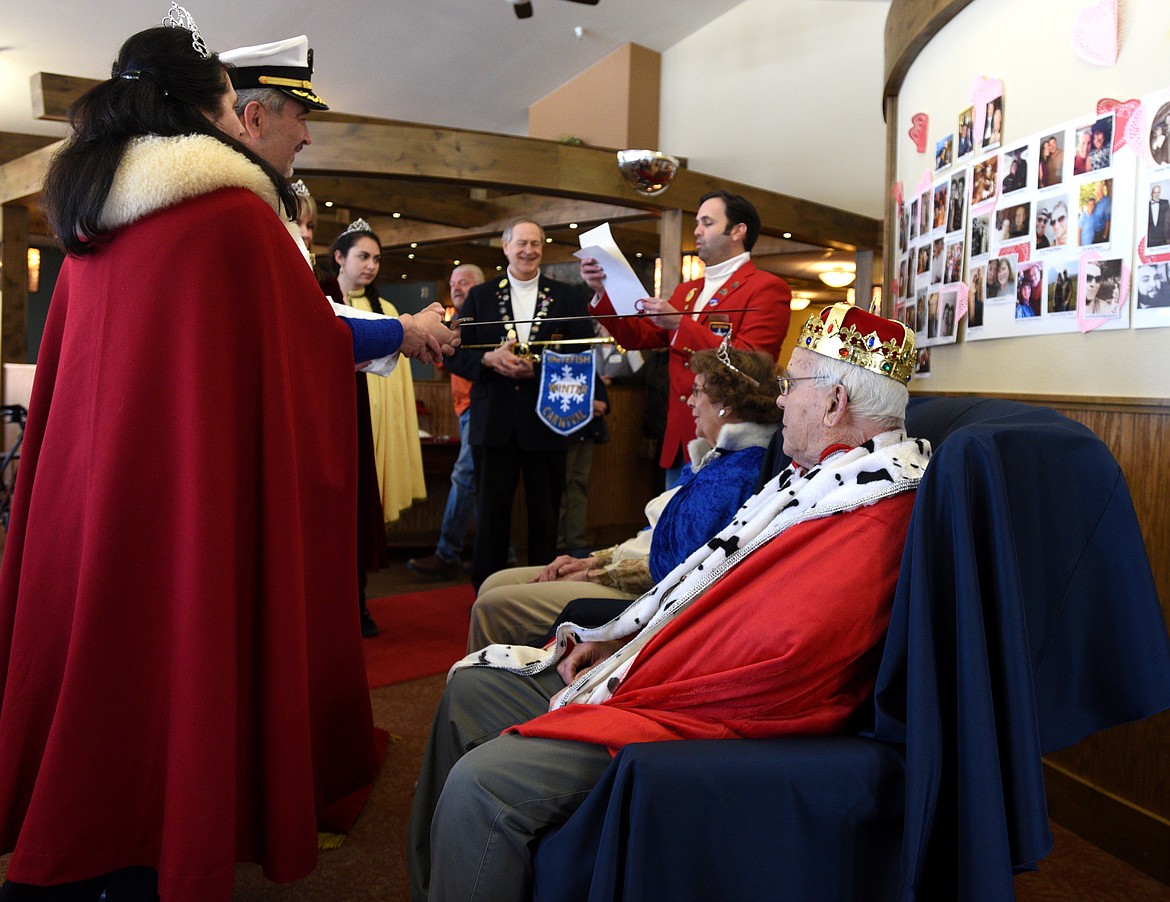 DOROTHY MUNDT and Paul Gould are knighted as the Queen and King of The Springs for the Whitefish Winter Carnival by carnival royalty on Wednesday.