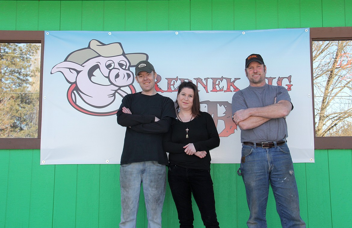 &#151;Photo by DAC COLLINS
From left to right, Ken Bateman, Mandi Bateman and Joe Haffner are the new managers of AJ&#146;s Lanes and Rednek Pig BBQ. Ken Bateman is the pitmaster and he makes everything in house, including a variety of tasty sauces. Their menu features pulled pork, spare ribs, smoked wings and a host of traditional sides such as tater salad and cole slaw. They also sell beer and wine. According to Mandi, the couple has lived in Bonners Ferry for about five years now and this is their first venture into the restaurant industry. Joe, who is a veteran and also a seasoned rodeo bullfighter, is a family friend of the Batemans and he has helped them get the ball rolling. &#147;We are looking forward to making this a family-friendly place,&#148; Mandi says.