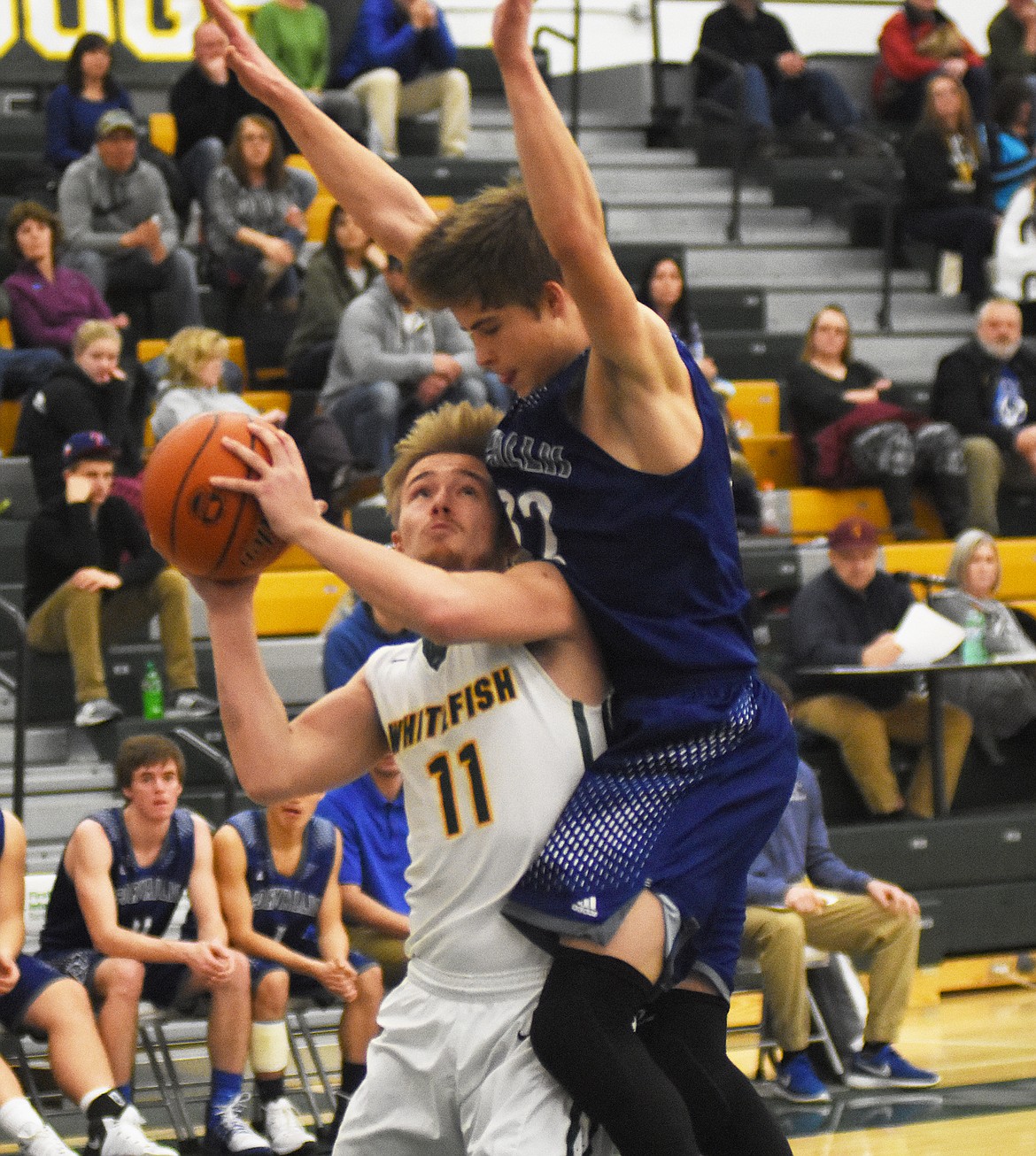 Zander Wold fights through contact against Corvallis on Friday. (Daniel McKay/Whitefish Pilot)