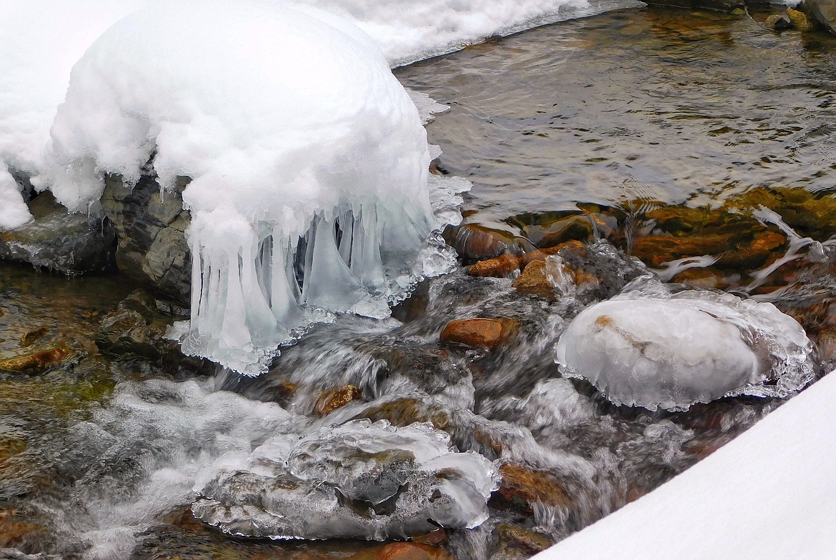 Snow and ice add contrast to the iron-rich stones that line the creek-beds of Ninemile Creek in the Silver Valley.