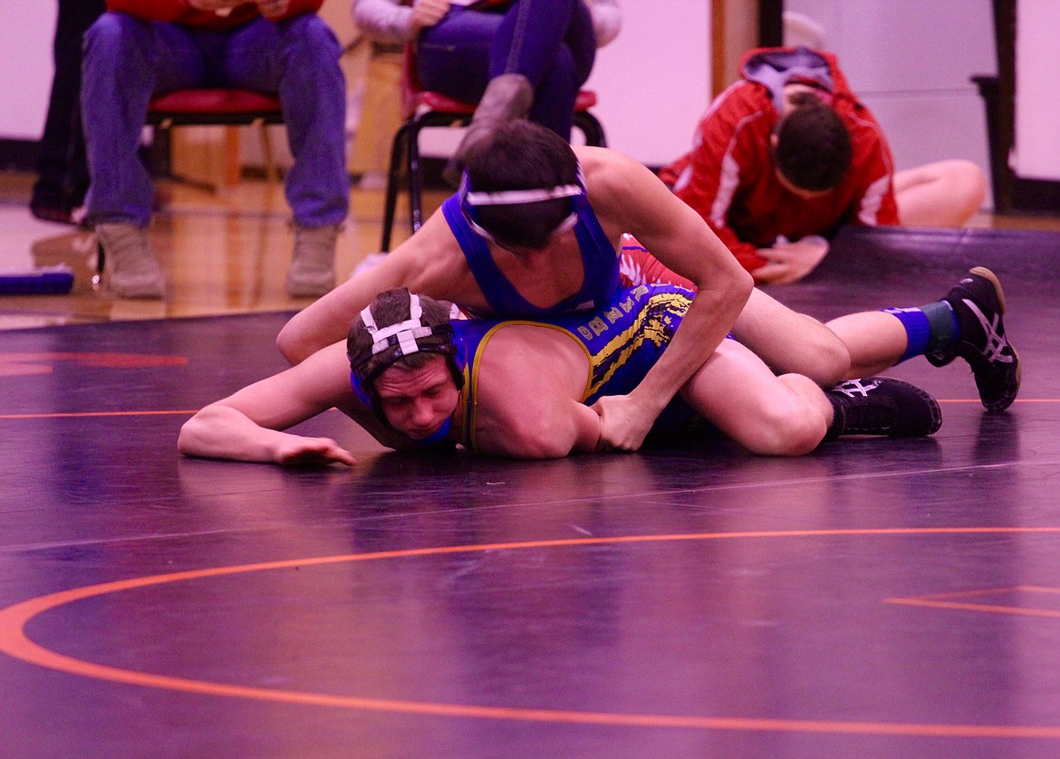 A PAIR of wrestlers head to the mat during Saturday&#146;s five-team mixer, in Plains. (Douglas Wilks/Clark Fork Valley Press)