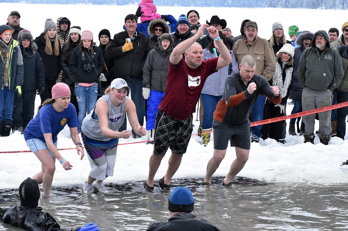 The Kalispell Police Department team jumps into Whitefish Lake Saturday morning during the annual Penguin Plunge at City Beach. The event raises money for Special Olympics Montana. (Heidi Desch/Whitefish Pilot)