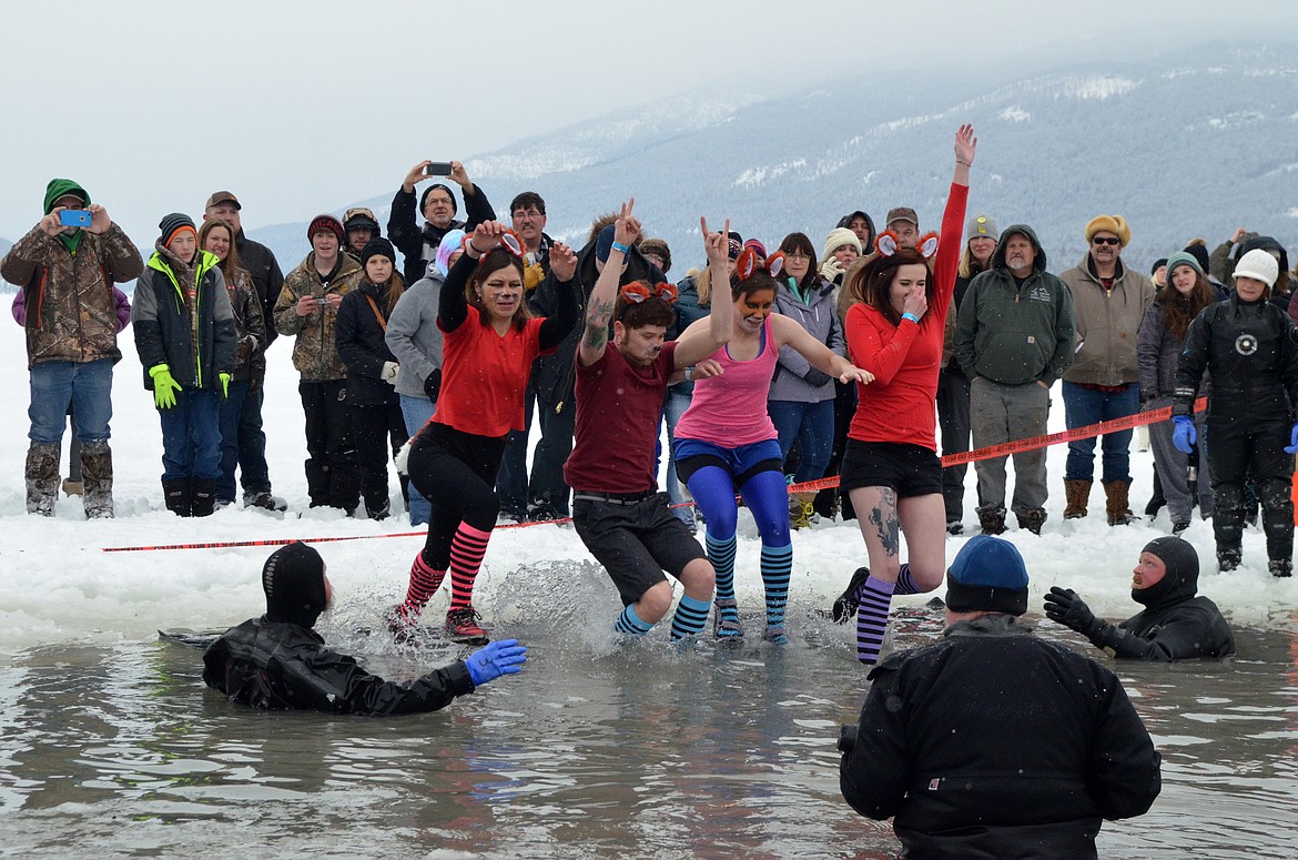 A group jumps into Whitefish Lake Saturday morning during the annual Penguin Plunge at City Beach. The event raises money for Special Olympics Montana. (Heidi Desch/Whitefish Pilot)