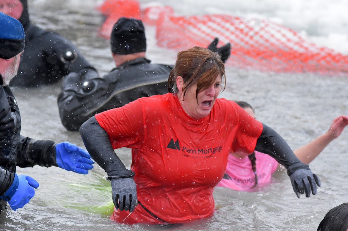 A plunger from the Mann Mortgage team emerges from the water after jumping into Whitefish Lake Saturday morning during the annual Penguin Plunge at City Beach. The event raises money for Special Olympics Montana. (Heidi Desch/Whitefish Pilot)