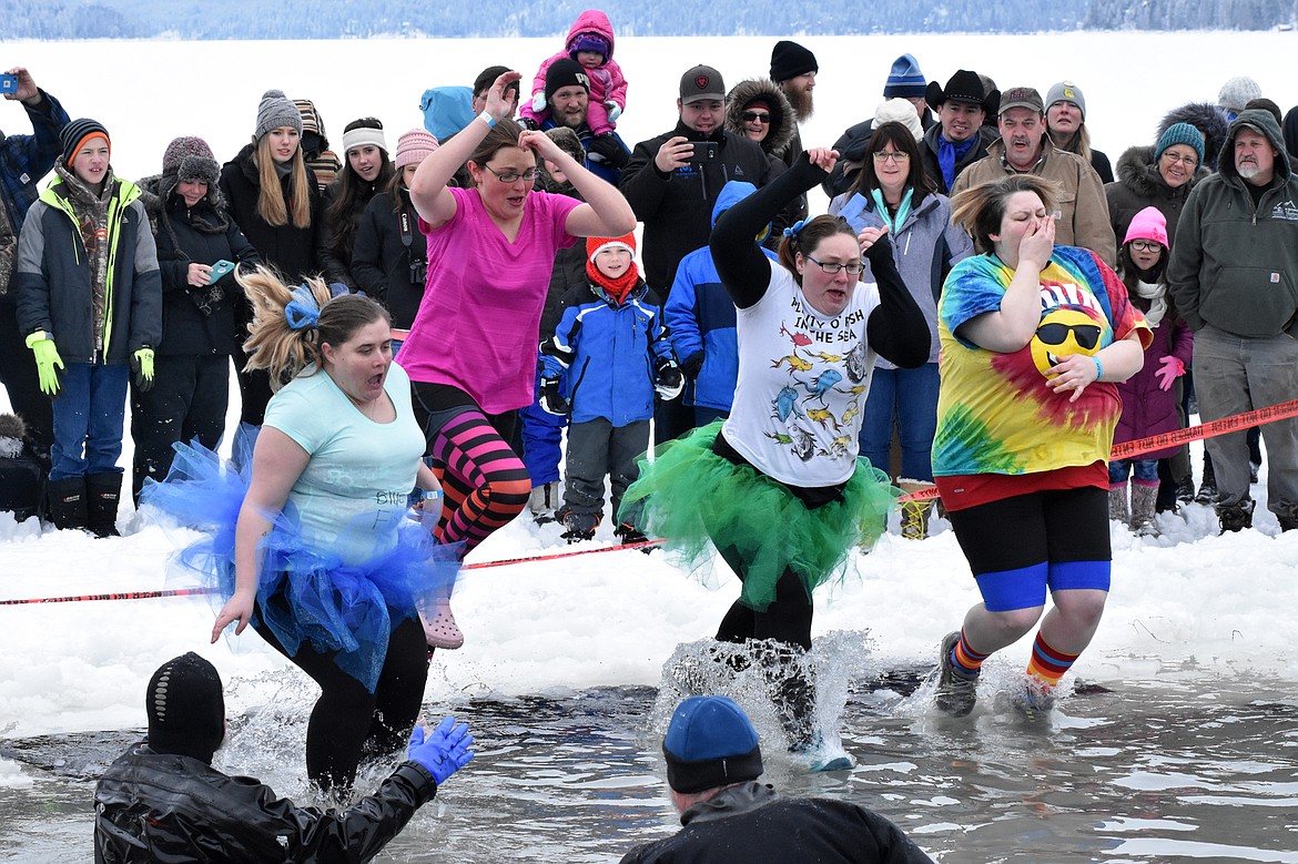 A group jumps into Whitefish Lake Saturday morning during the annual Penguin Plunge at City Beach. The event raises money for Special Olympics Montana. (Heidi Desch/Whitefish Pilot)