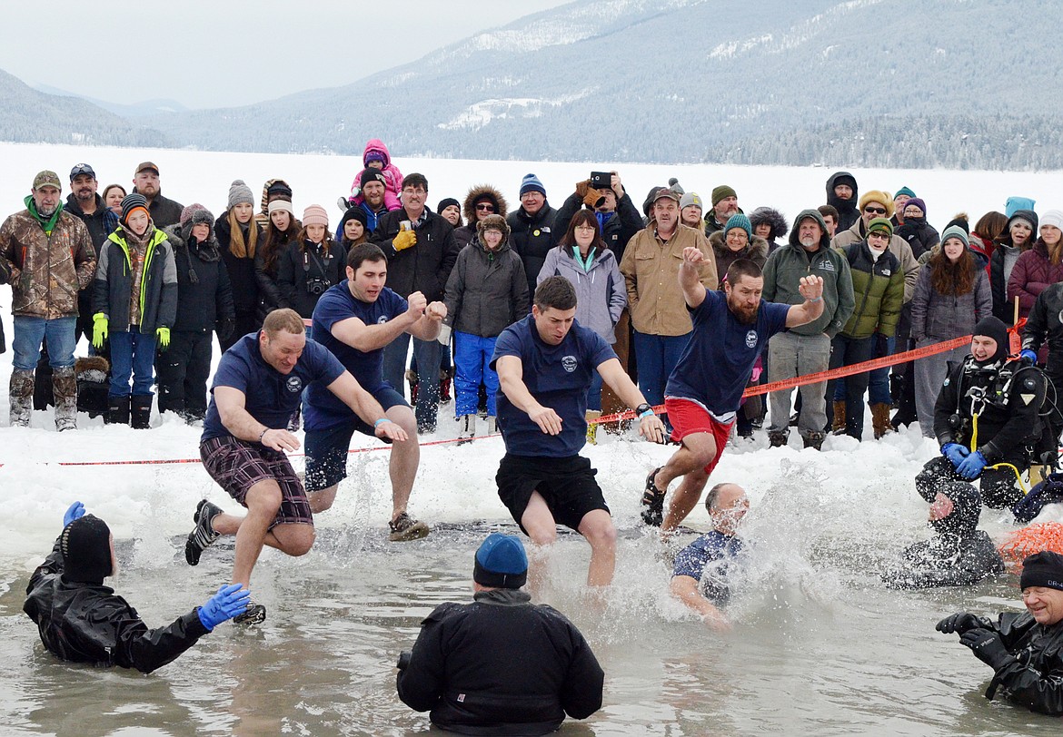 The Whitefish Police Department group jumps into Whitefish Lake Saturday morning during the annual Penguin Plunge at City Beach. The event raises money for Special Olympics Montana. (Heidi Desch/Whitefish Pilot)