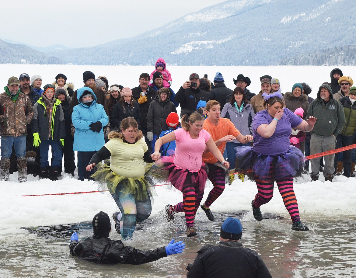 A group jumps into Whitefish Lake Saturday morning during the annual Penguin Plunge at City Beach. The event raises money for Special Olympics Montana. (Heidi Desch/Whitefish Pilot)