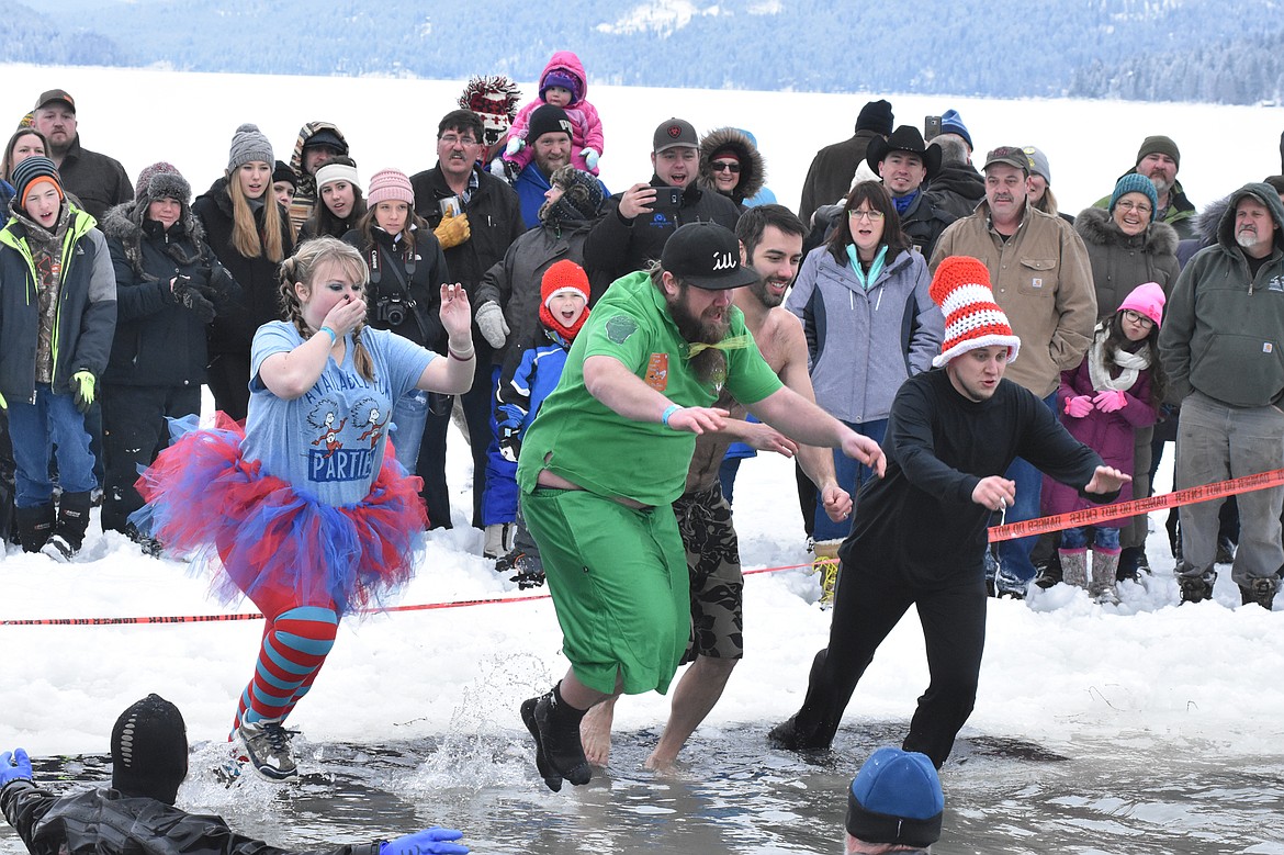 A group jumps into Whitefish Lake Saturday morning during the annual Penguin Plunge at City Beach. The event raises money for Special Olympics Montana. (Heidi Desch/Whitefish Pilot)