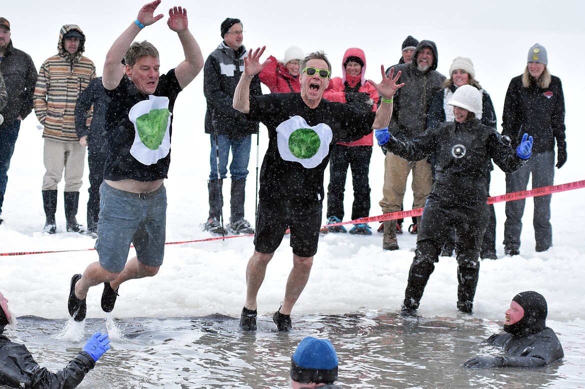 A group jumps into Whitefish Lake Saturday morning during the annual Penguin Plunge at City Beach. The event raises money for Special Olympics Montana. (Heidi Desch/Whitefish Pilot)