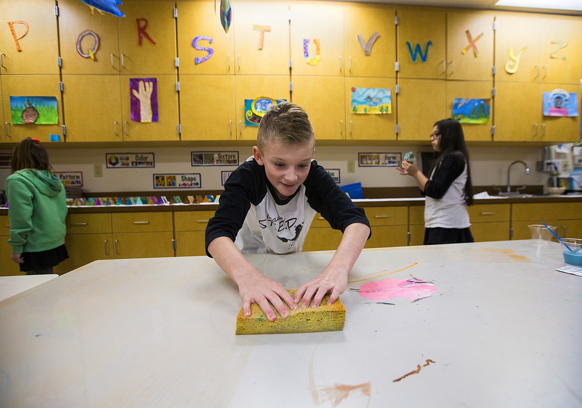 LOREN BENOIT/Press

Sorensen Magnet School fifth-grader Austin Frosberg cleans a table Thursday morning after paining wood blocks displays for the Coeur d&#146;Alene Seed Sharing Library True to Seed program.