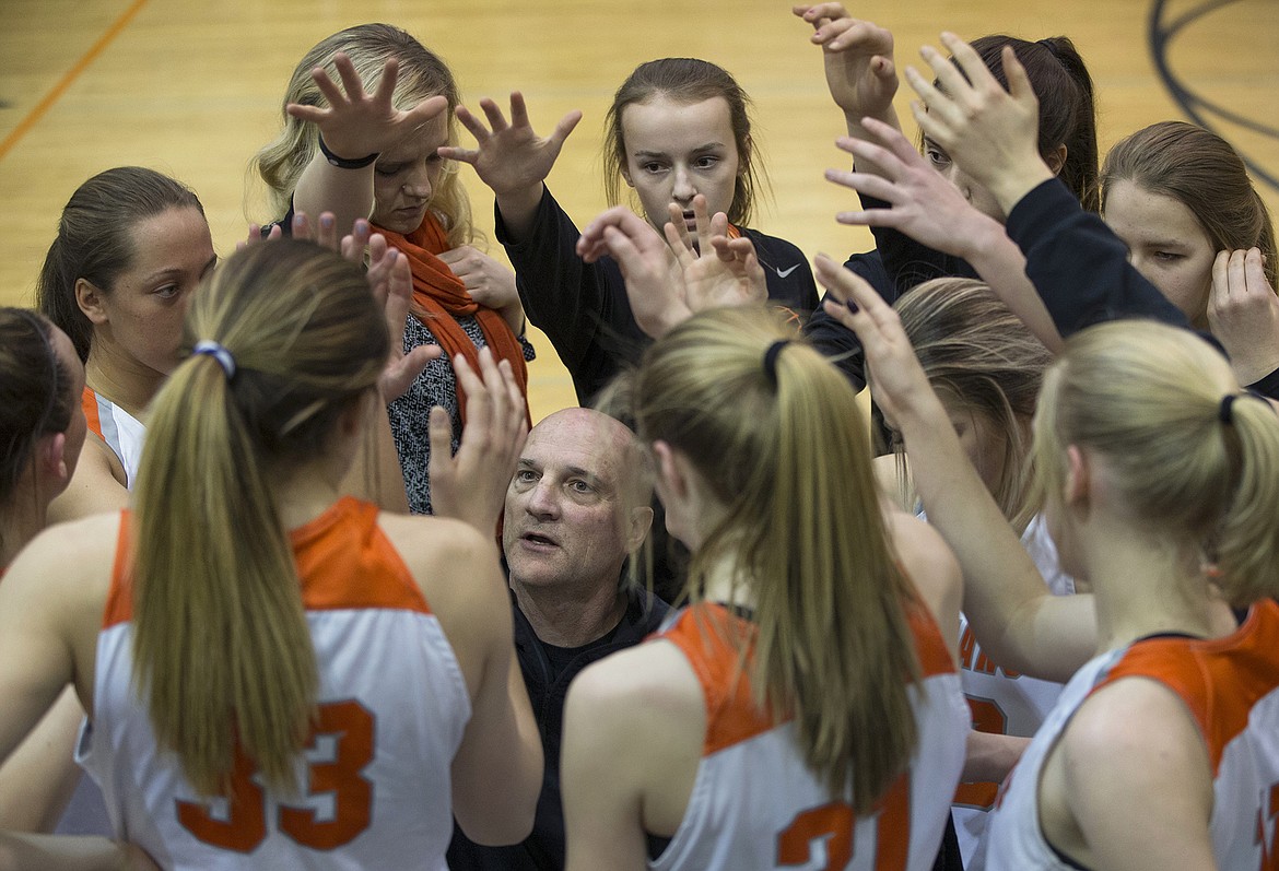 LISA JAMES/ PressPost Falls Varsity High School basketball coach rallies his team during the last few minutes of their championship game against Lewiston High School on Tuesday night at Post Falls High School.