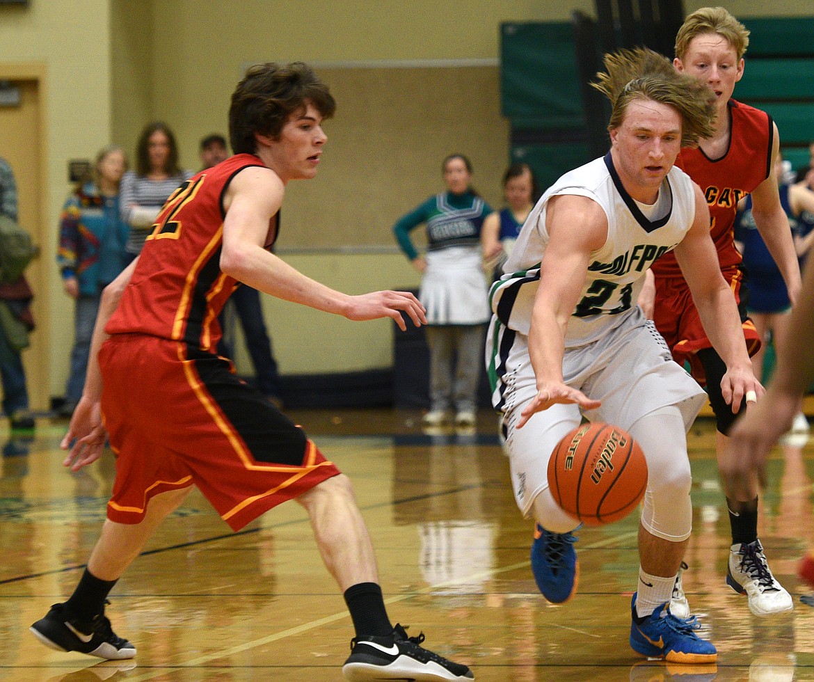 Glacier forward Pat O'Connell dribbles through the Missoula Hellgate press during the second quarter at Glacier. (Aaric Bryan/Daily Inter Lake)