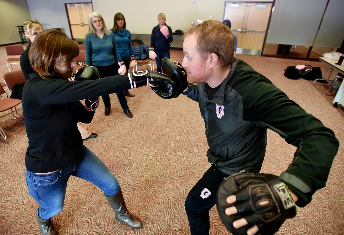 JILL SEIGMUND, left, punches with Garret Garrels of Pink Gloves Boxing at Flathead County Community College on Feb. 3. The program started with a group of women but has swiftly grown to include 30 U.S. locations. (Brenda Ahearn photos/Daily Inter Lake)