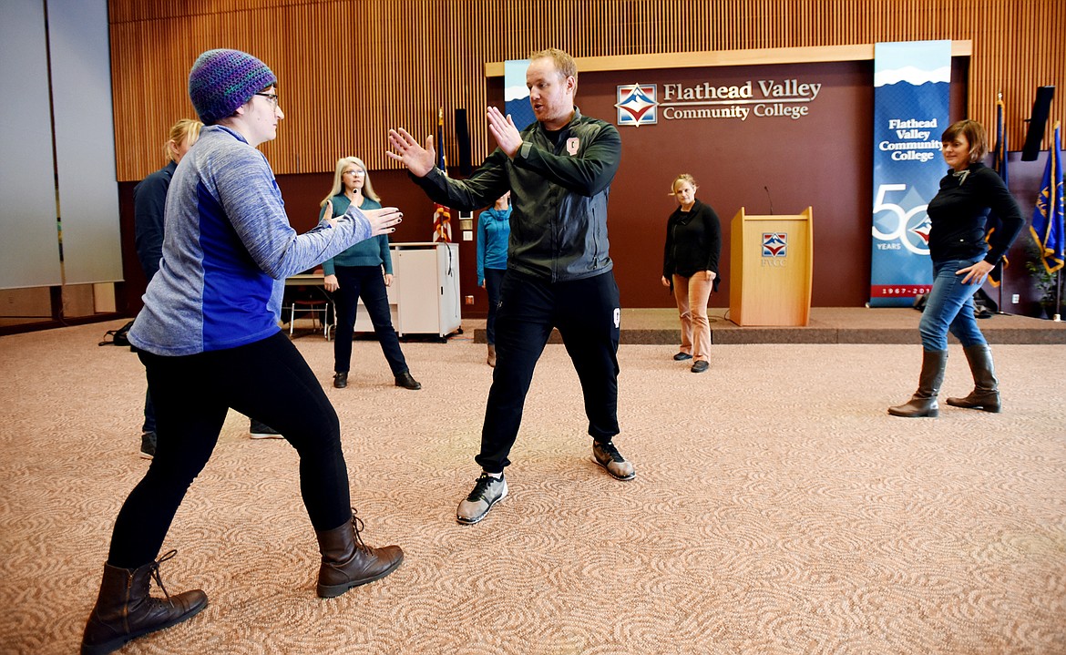 Sierra Hutchinson works on her boxing stance with Garret Garrels of Pink Glove Boxing on Friday, February 3, at Flathead Valley Community College.(Brenda Ahearn/Daily Inter Lake)