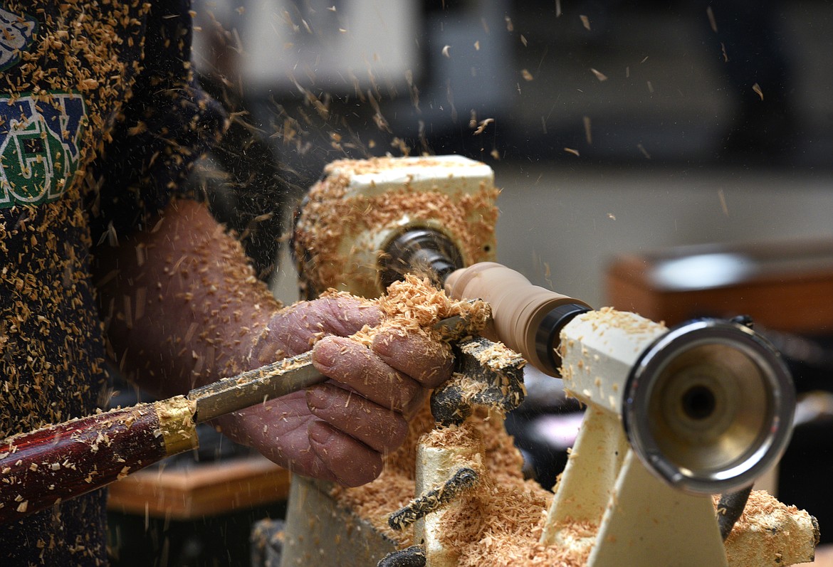 Ted Luehr carves a leg for a stool during the Glacier Woodturners demonstration at the Kalispell Center Mall on Saturday. (Aaric Bryan/Daily Inter Lake)