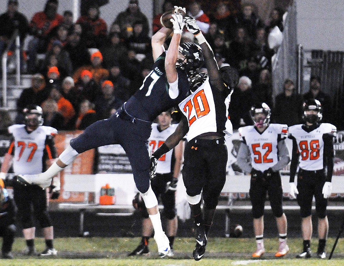 Glacier&#146;s Noah Lindsay hauls in a catch as Flathead&#146;s Nate Sommers attempts to break it up at Legends Stadium on Friday. (Aaric Bryan/Daily Inter Lake)