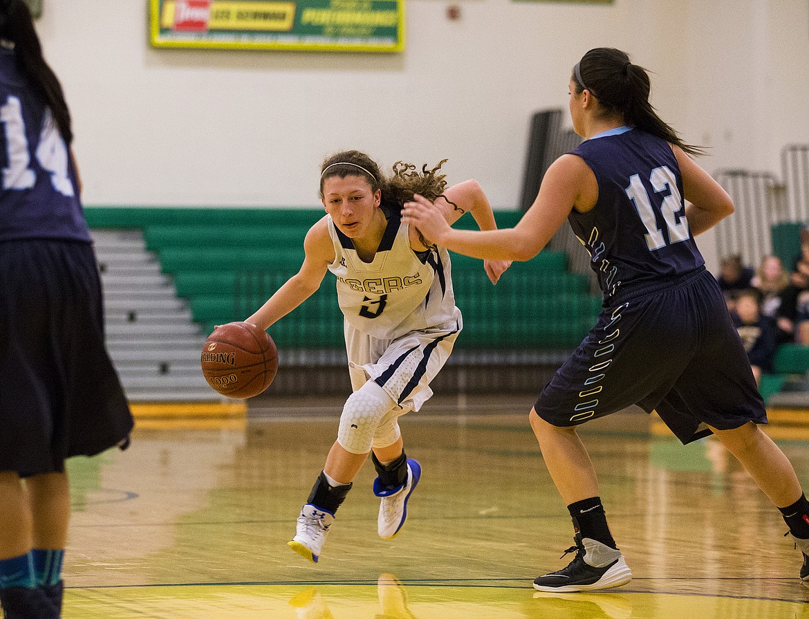 LOREN BENOIT/PressLilly Kelley (3) of Timberlake, drives past Britany Spangler of Bonners Ferry in the 3A District 1 Championship game Friday night at Lakeland High School.