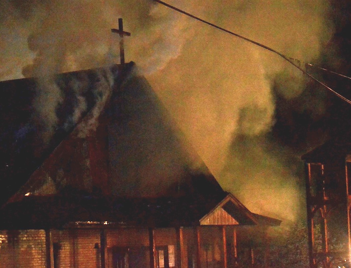 &#151;Photo by SARAH JENKINS Smoke pours from St. Ann&#146;s Catholic Church in Bonners Ferry after what authorities believe to be an arson-caused explosion during the early morning hours of  Thursday, April 21, 2016. By the time fire crews arrived, the church was fully engulfed in flames.