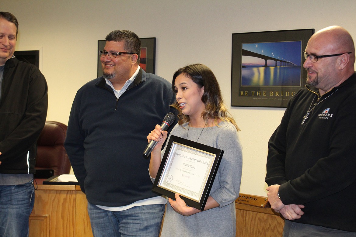 Cheryl Schweizer/Columbia Basin Herald
Sandra Garza (center) was one of three Othello Teachers of the Year. Garza and fellow teachers Jennifer McCourtie and Brenda Young were recognized at the Othello School Board meeting Monday. Garza is pictured with board members Juan Garza (left) and Mike Garza (right).