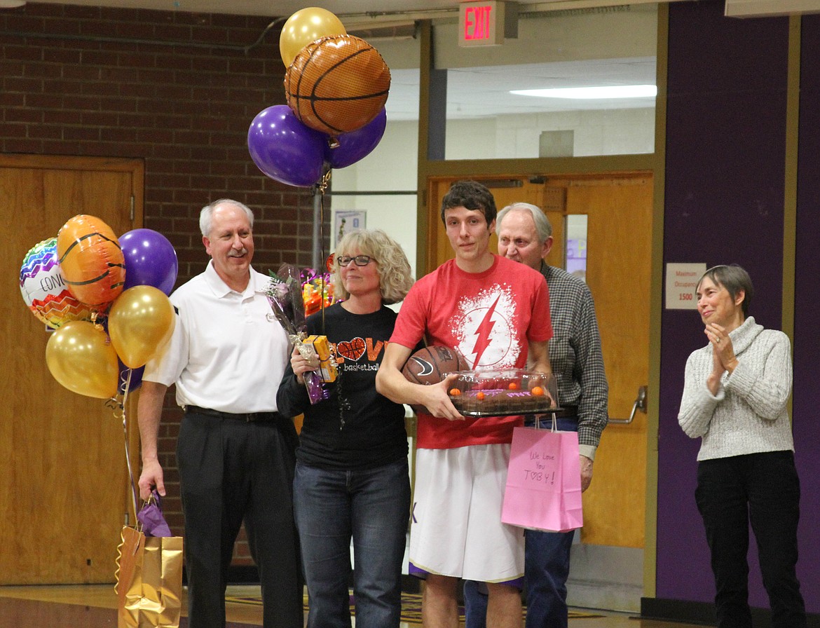 Photo by Josh McDonald
Senior Toby Colburn stands with his family during the Kellogg basketball team&#146;s senior night festivities prior to the game.