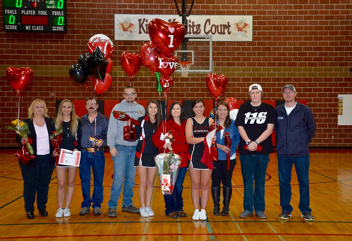 Photo courtesy of Stacey Strange.
Wallace seniors Rebecca Whiteside, Lindsey Strange, Hope Spears, and Jordan House pose for the camera with their families during the recognition ceremony before Thursday's game.