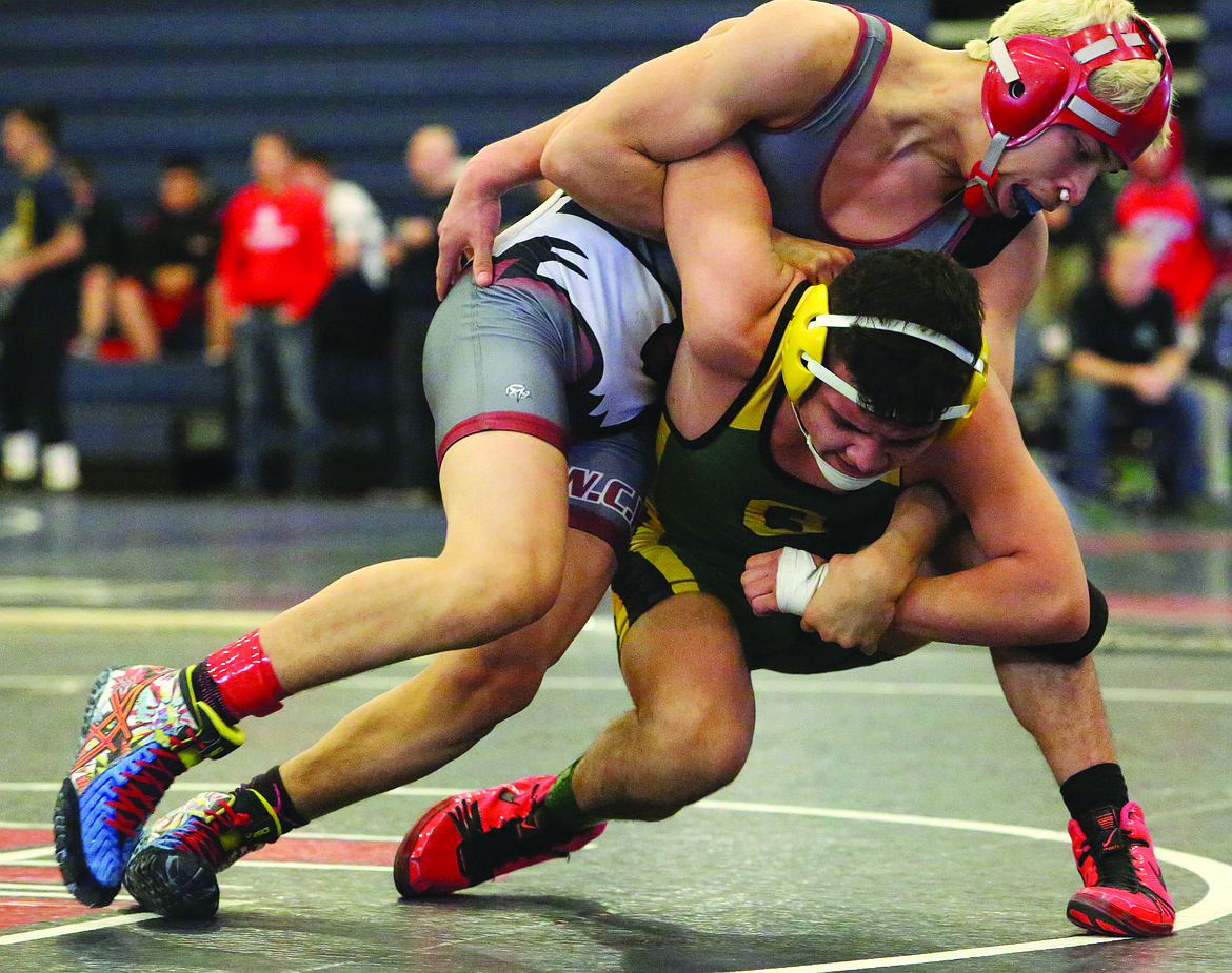 Connor Vanderweyst/Columbia Basin Herald
Quincy's Raul Barajas (green) tries to free himself from Toppenish's Isaac John.